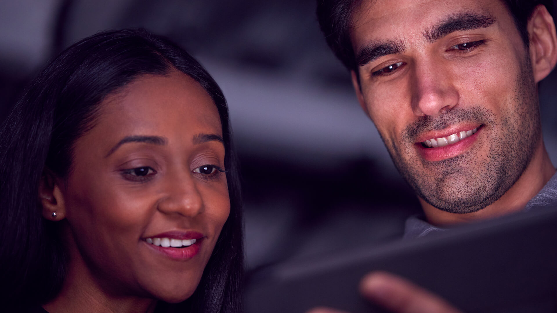 Friends sharing a mobile experience together at a live event